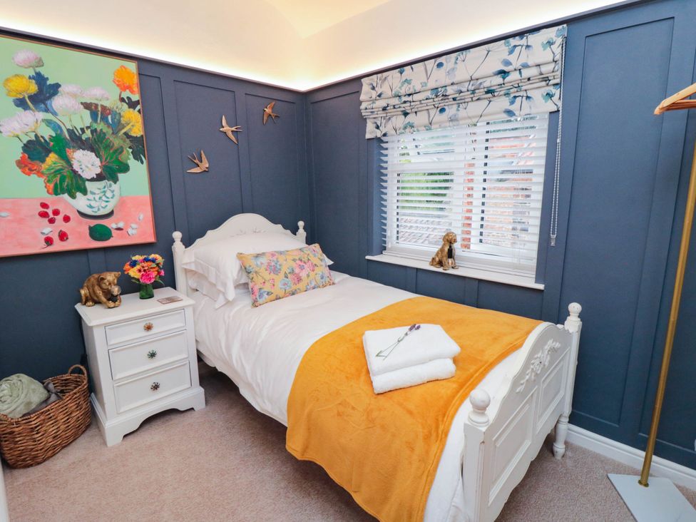 A bedroom with a bed and artwork at 5 South Side