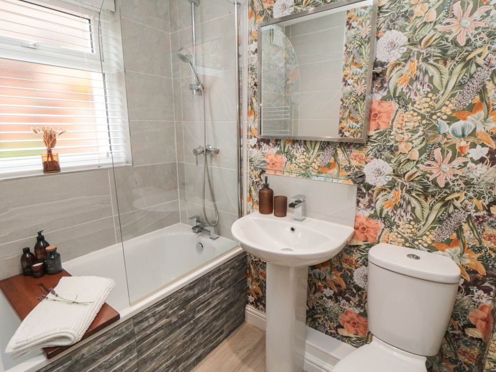 A bathroom with a bathtub and sink at 5 South Side 