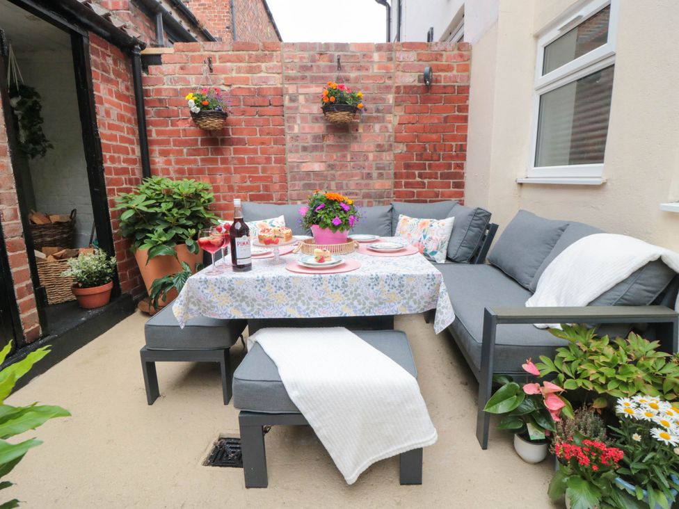 An outdoor seating area with a table and sofa at 5 South Side