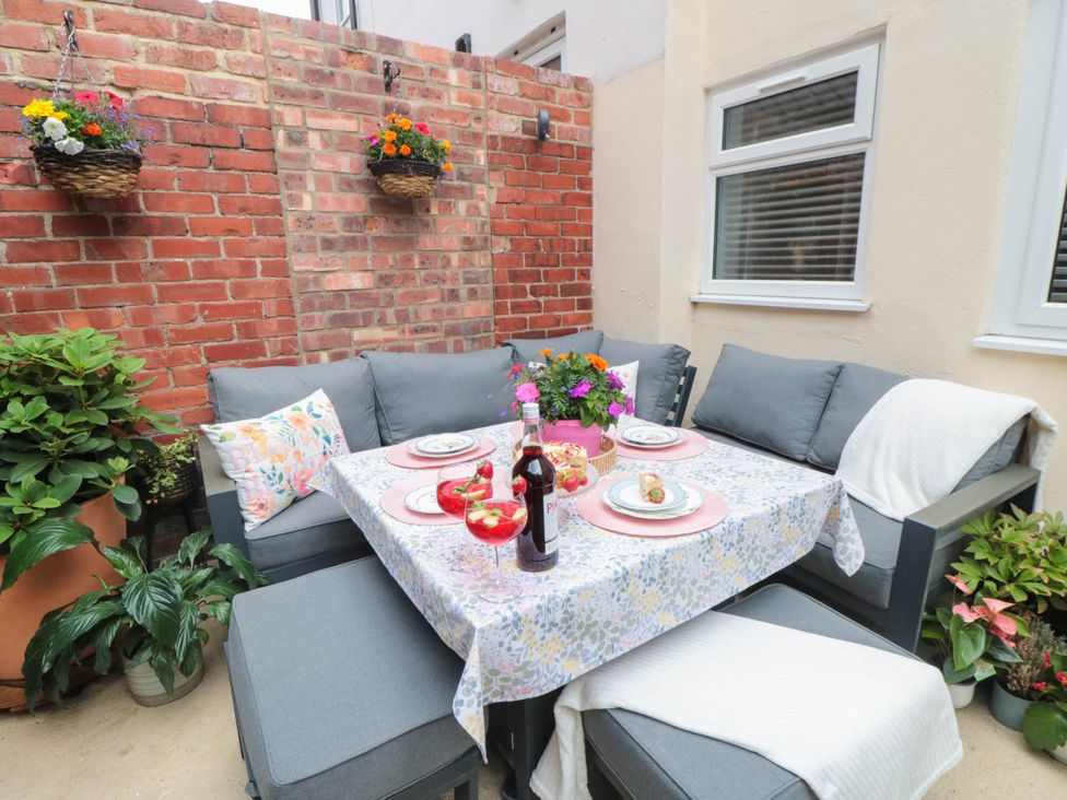 An outdoor dining area with a table and sofa at 5 South Side