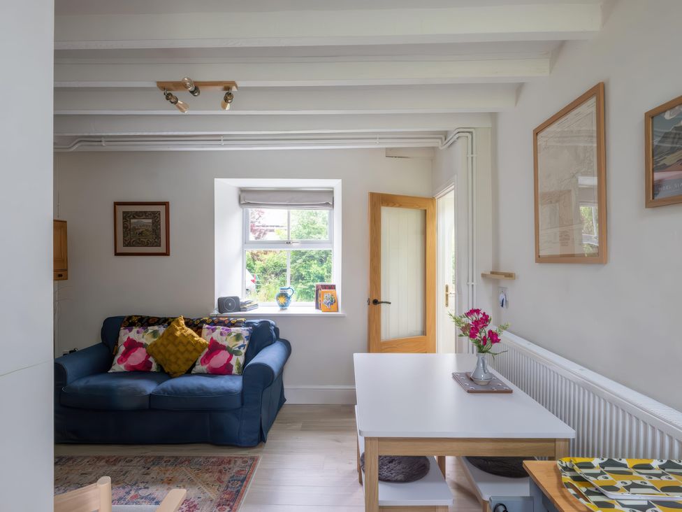A living room with a sofa and table at 1 Aberbeinw in Dolwyddelan