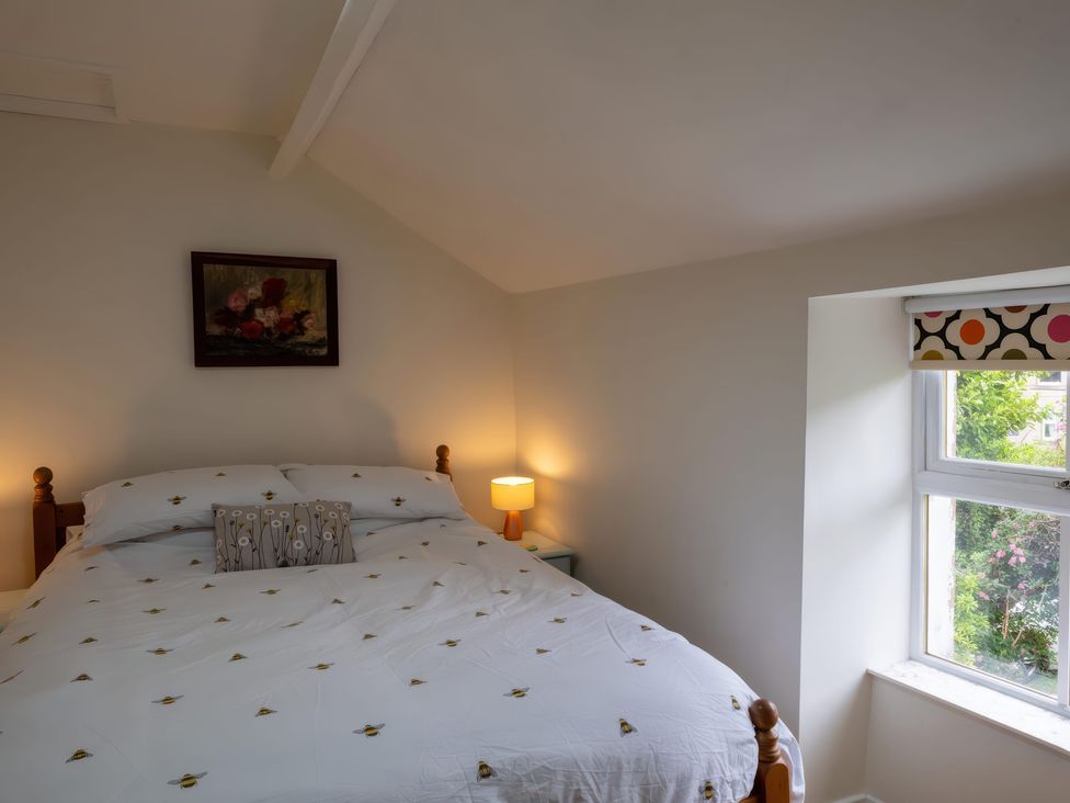 A bedroom with a bed and window at 1 Aberbeinw in Dolwyddelan