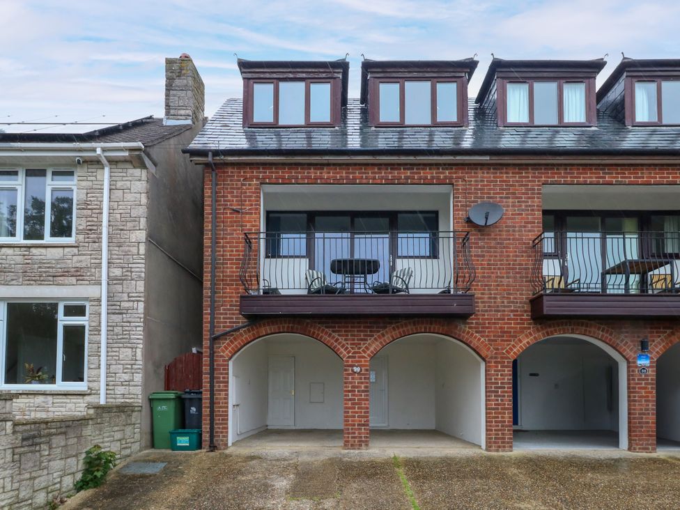 A residential building with a balcony and garage at The View in Weymouth