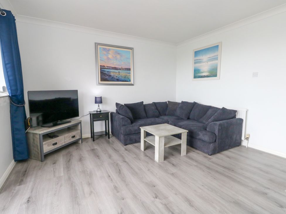 A living room with a sofa and television at The View in Weymouth