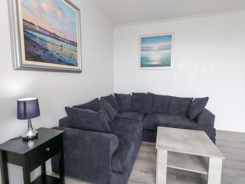 A living room with a sofa and coffee table at The View in Weymouth