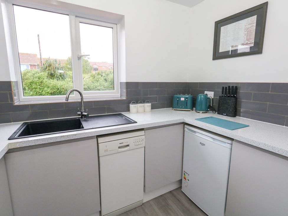 A kitchen with appliances and a window at The View in Weymouth