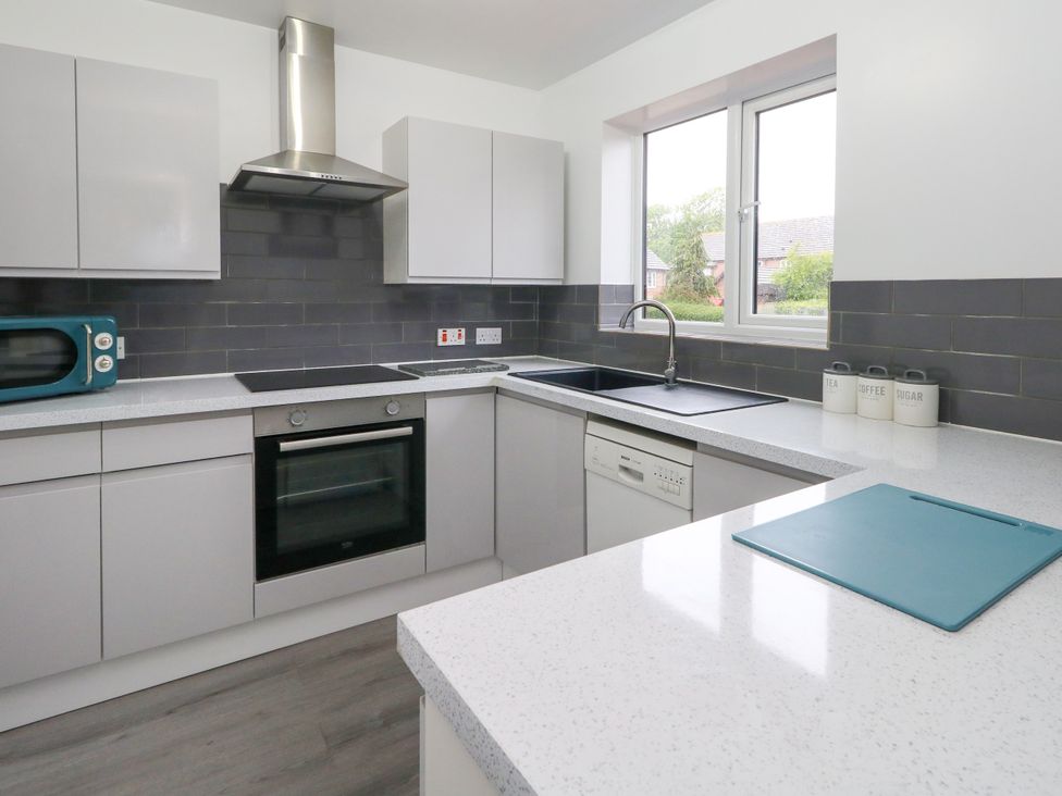 A kitchen with appliances and cabinets at The View in Weymouth
