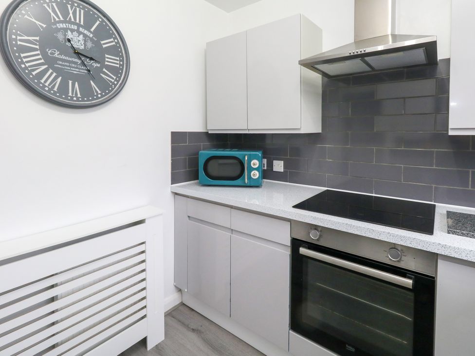 A kitchen with a microwave and oven at The View in Weymouth