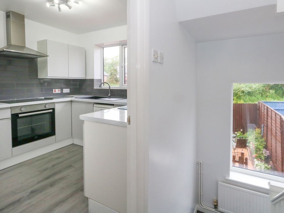 A kitchen with modern cabinets and a window at The View in Weymouth