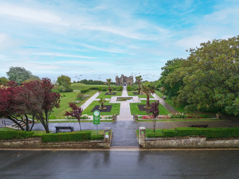 A garden with pathways and benches at The View in Weymouth