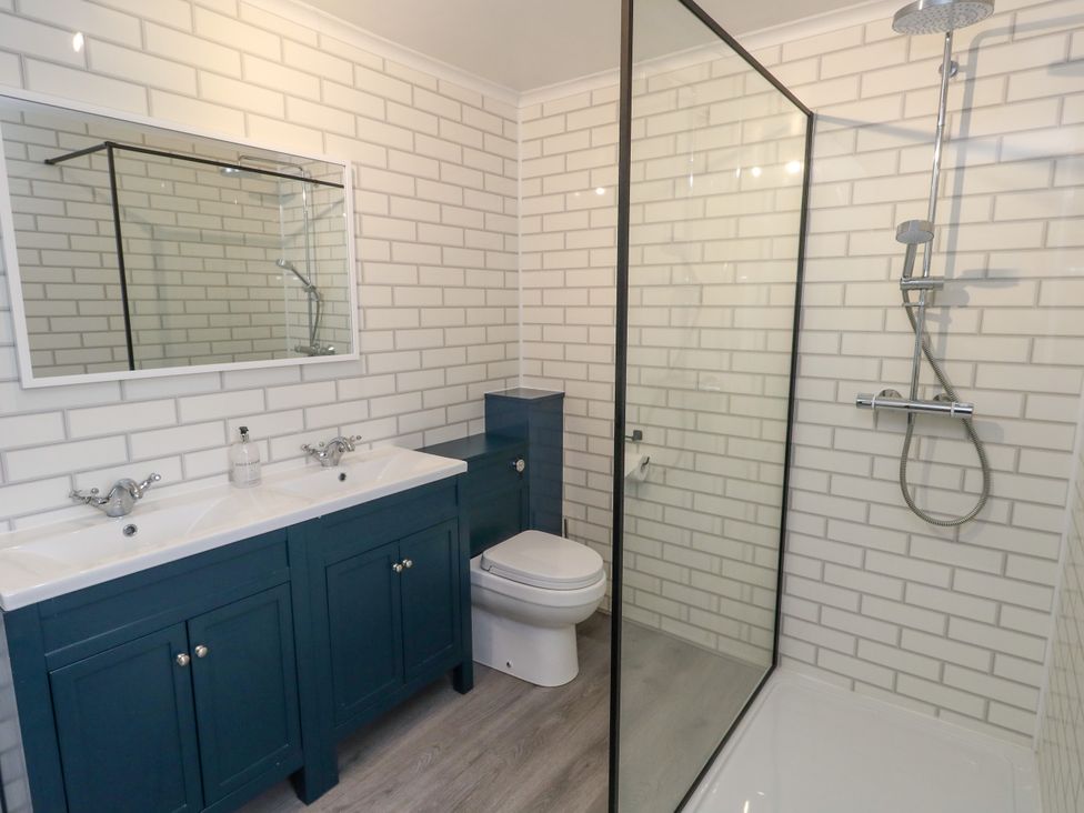 A bathroom with a sink, toilet, and shower at The View in Weymouth