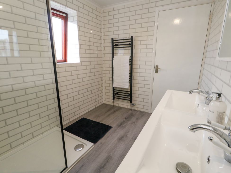 A bathroom with a shower and sink at The View in Weymouth