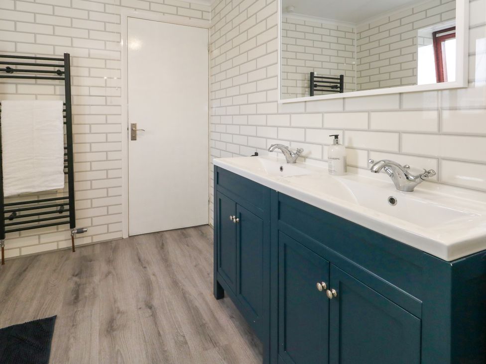 A bathroom with a double sink and mirror at The View in Weymouth