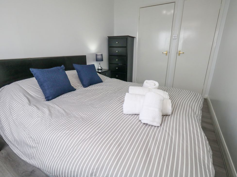 A bedroom with a bed and towels arranged at The View in Weymouth