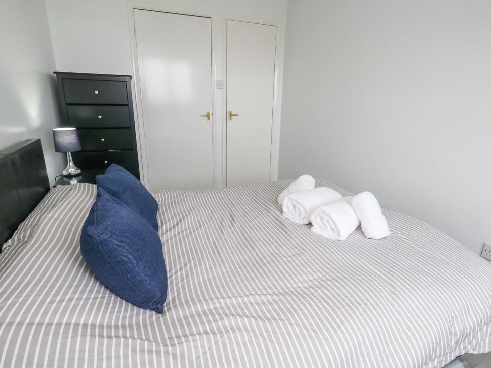 A bedroom with a bed and towels on it at The View in Weymouth