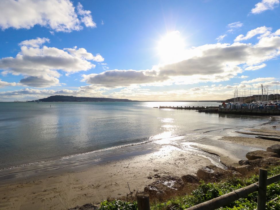 A view of the beach and water under blue sky with clouds at The View in Weymouth