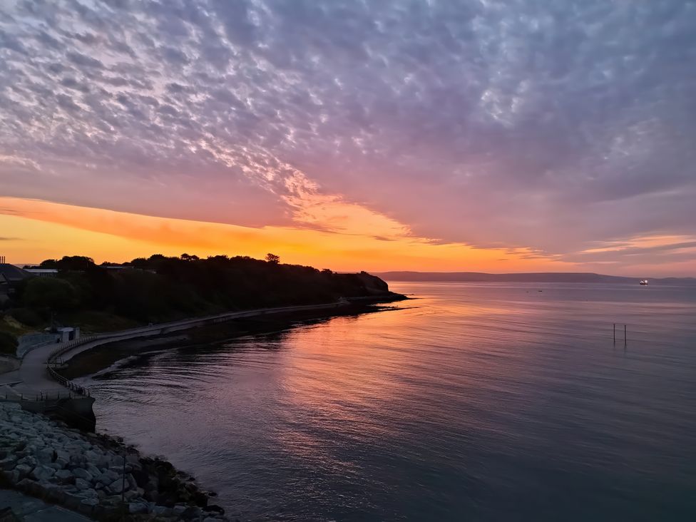 A sunset view over the water with clouds at The View in Weymouth