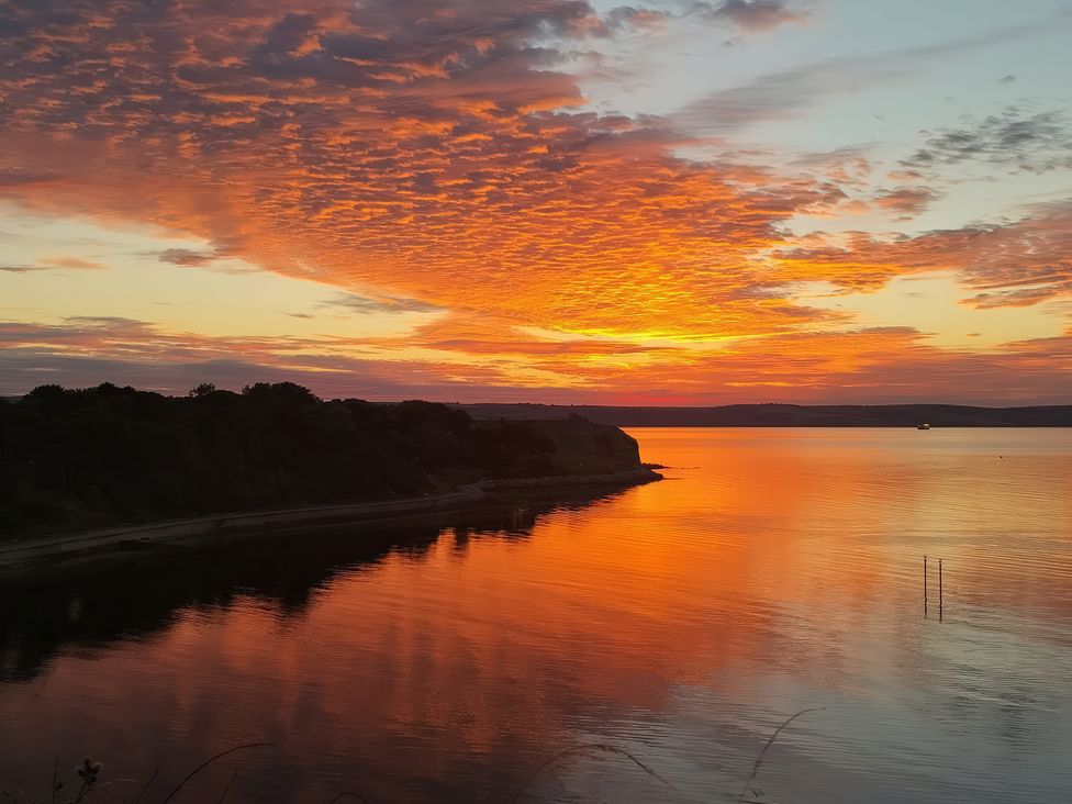 A sunset over water with colorful sky at The View in Weymouth