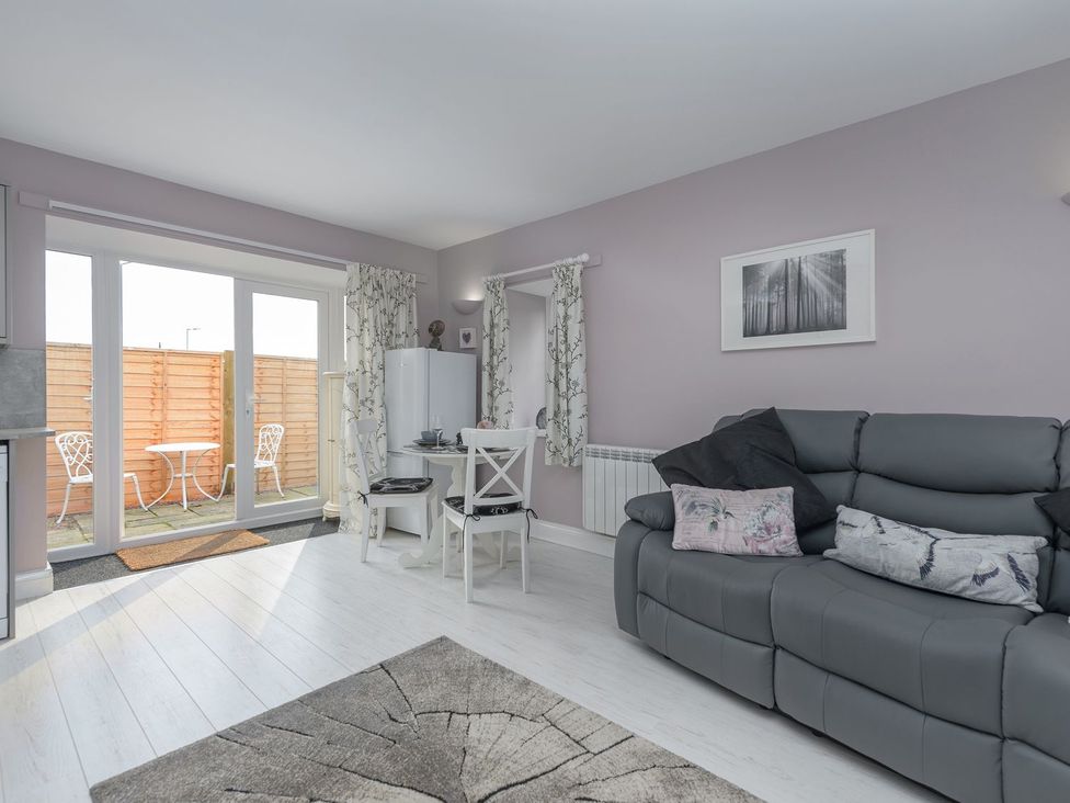 A living room with a sofa and a dining table at The Forge in Morpeth