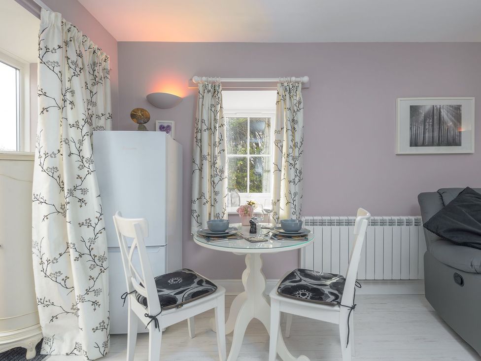 A kitchen with a refrigerator and dining area at The Forge in Morpeth