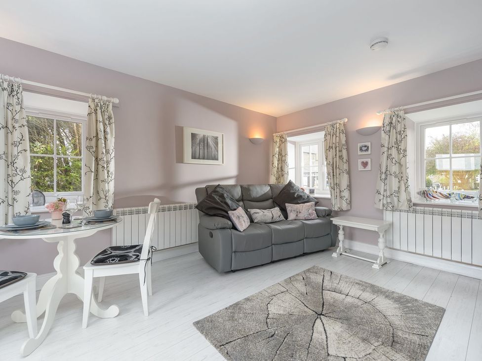 A living room with a sofa and dining table at The Forge in Morpeth
