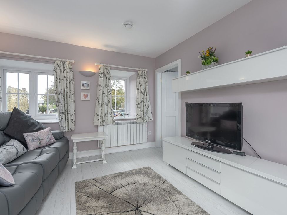 A living room with a sofa and television at The Forge in Morpeth