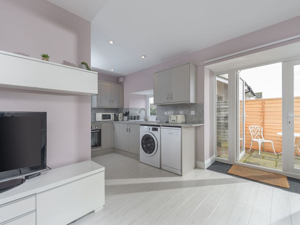 A kitchen with appliances and a door leading outside at The Forge in Morpeth