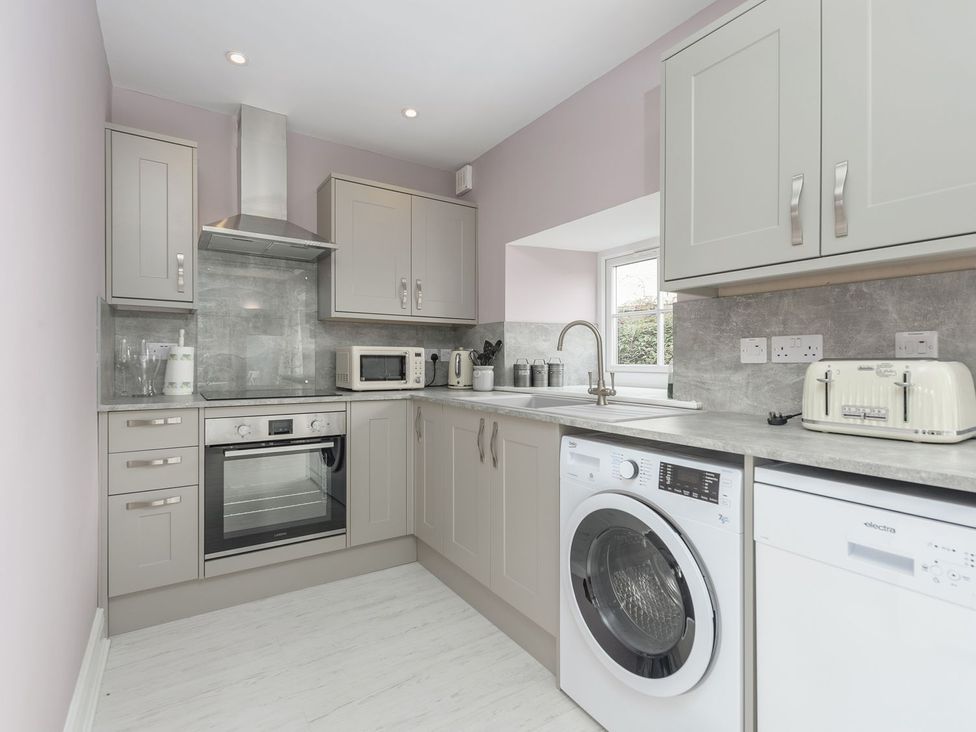 A kitchen with appliances and cabinets at The Forge in Morpeth