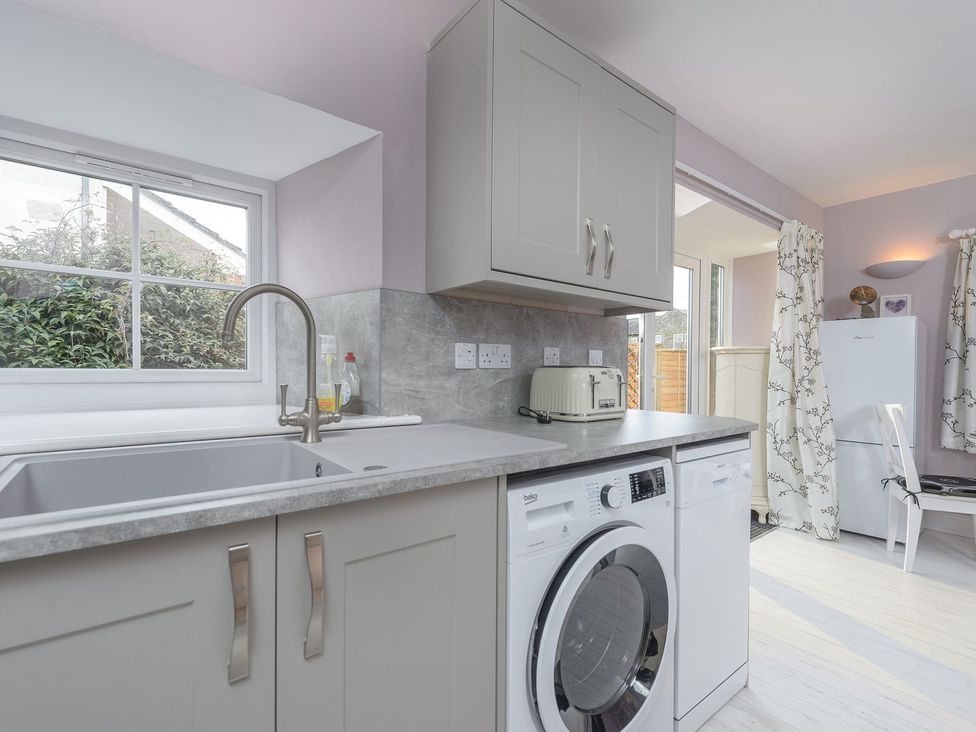 A kitchen with a sink and washing machine at The Forge in Morpeth