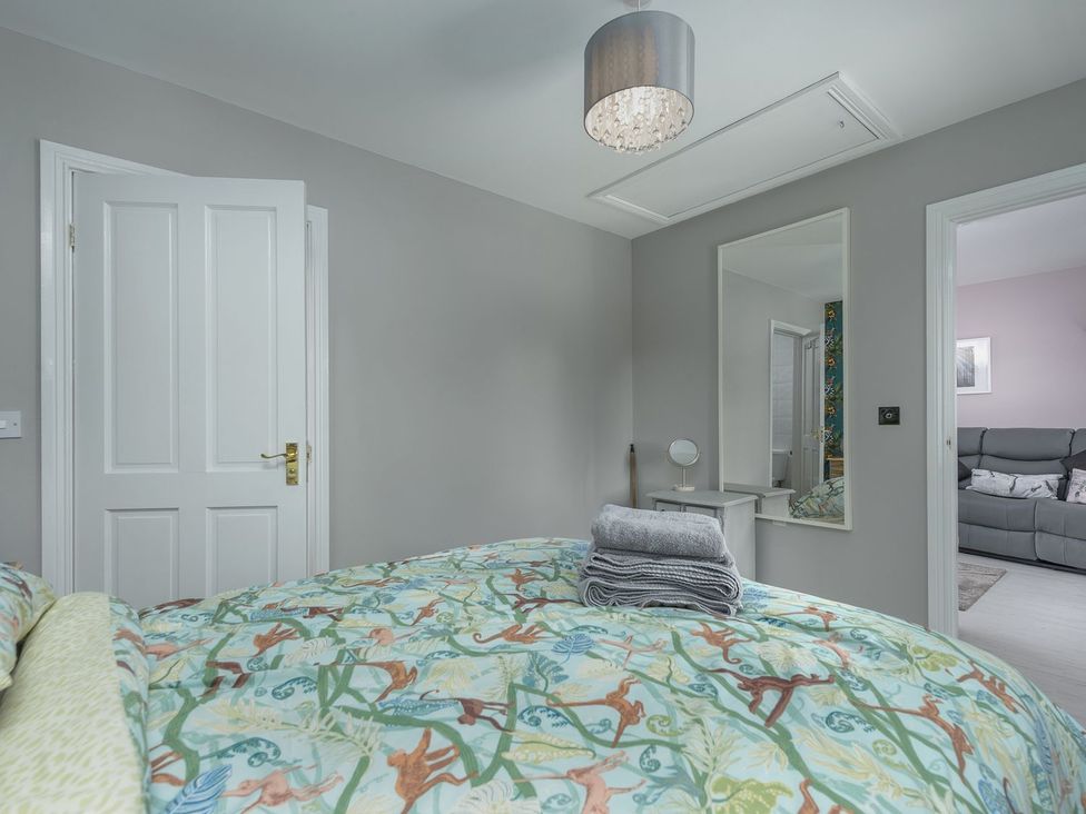 A bedroom with a bed and a mirror at The Forge in Morpeth