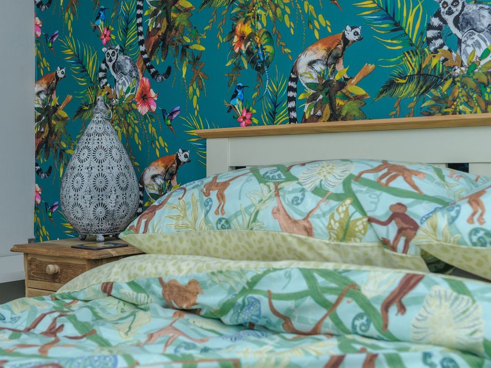 A bedroom with a bed and patterned pillows at The Forge in Morpeth