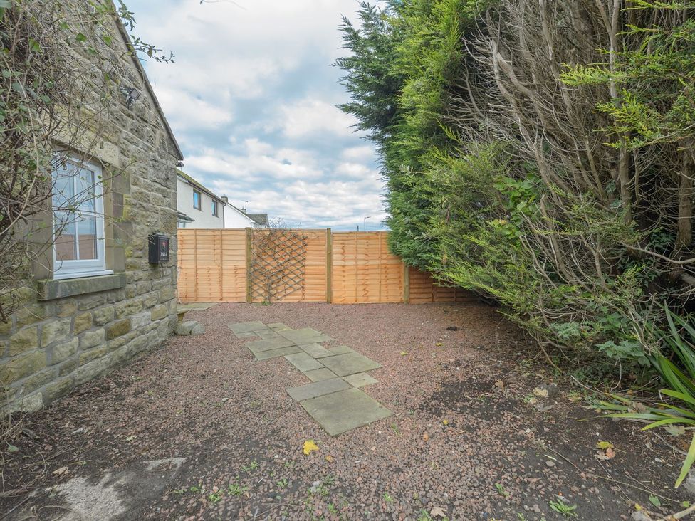An outdoor area with a stone wall and path at The Forge in Morpeth