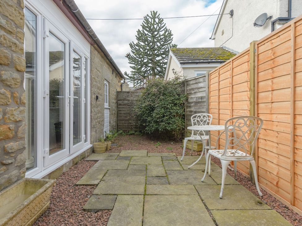 A garden area with chairs and a table at The Forge in Morpeth