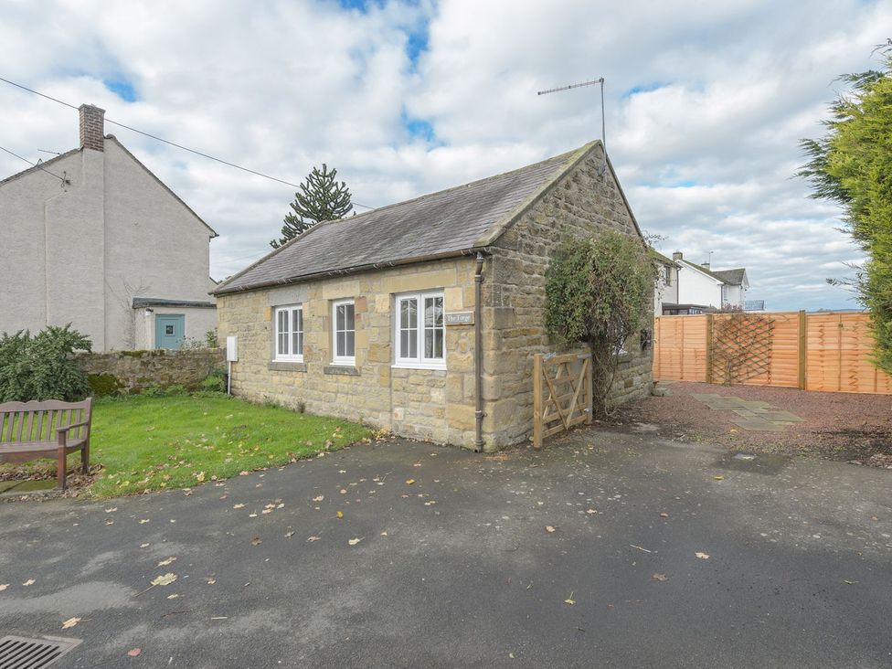 A cottage with a gate and grassy area at The Forge in Morpeth