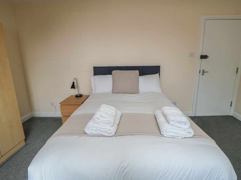 A bedroom with a bed and nightstand at The Newborough Apartment 5 Scarborough