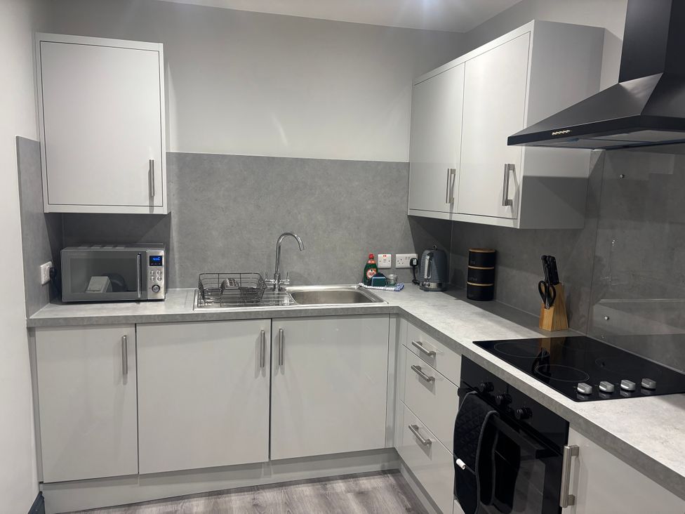 A kitchen with a sink and appliances at The Newborough Apartment 1 Scarborough