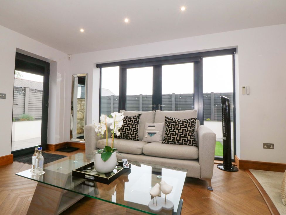 A living room with a sofa and coffee table at Lodge in Llangefni