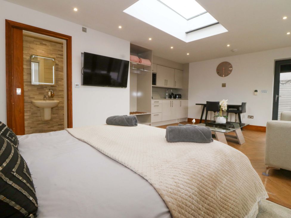 A bedroom with a bed and television at Lodge in Llangefni