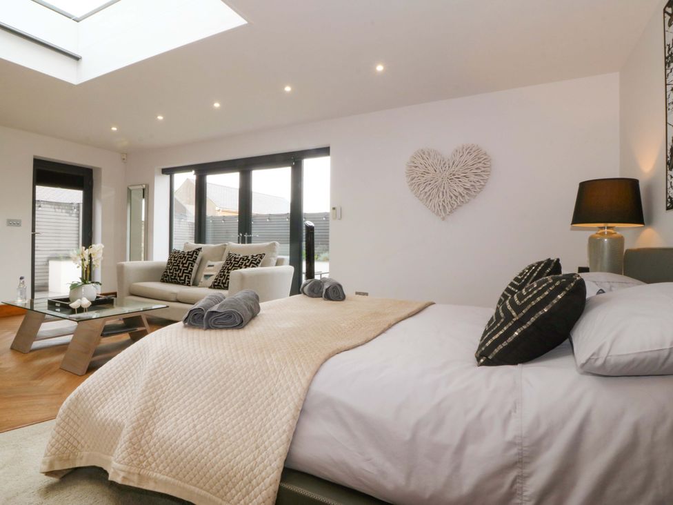 A bedroom with a bed and seating area at Lodge in Llangefni