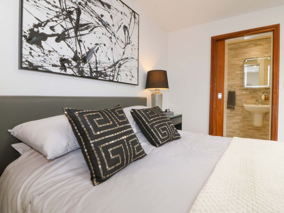 A bedroom with a bed and artwork at Lodge in Llangefni