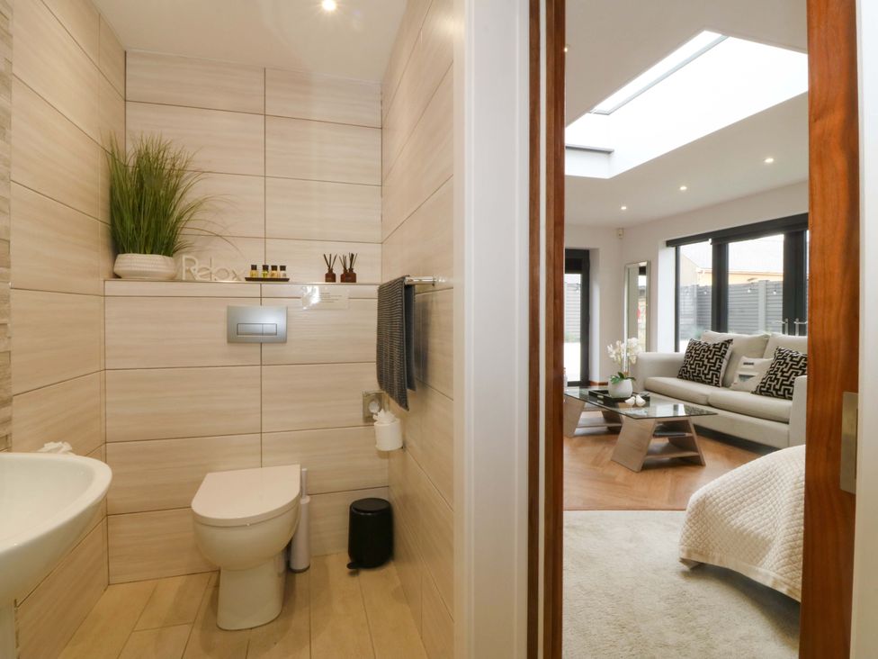 A bathroom with a toilet and washbasin at Lodge in Llangefni
