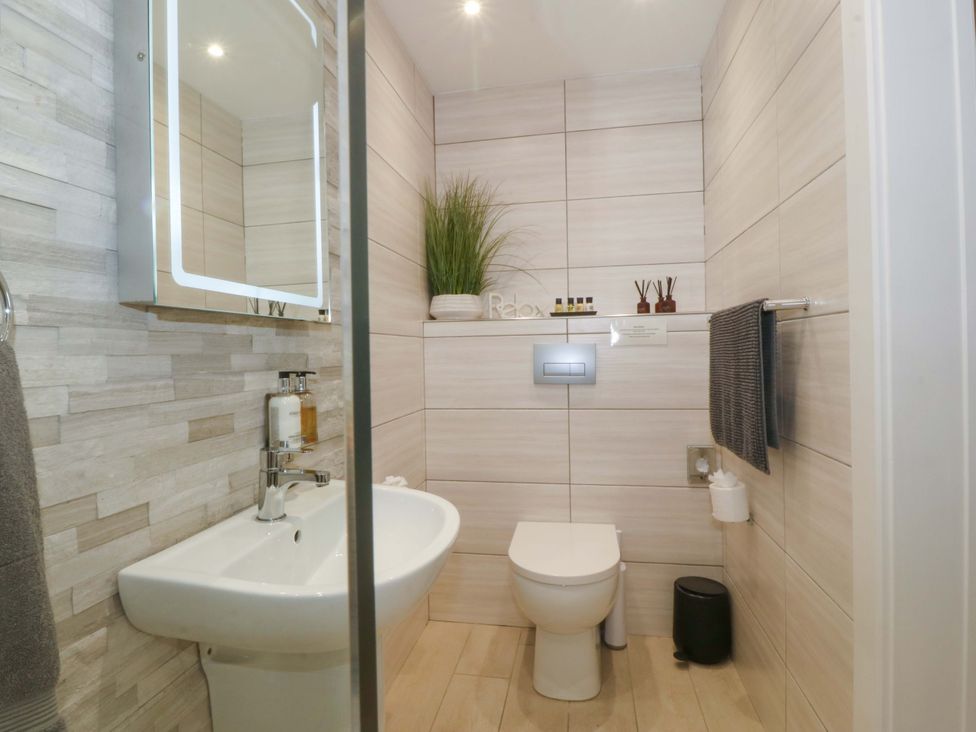 A bathroom with a sink and toilet at Lodge Llangefni