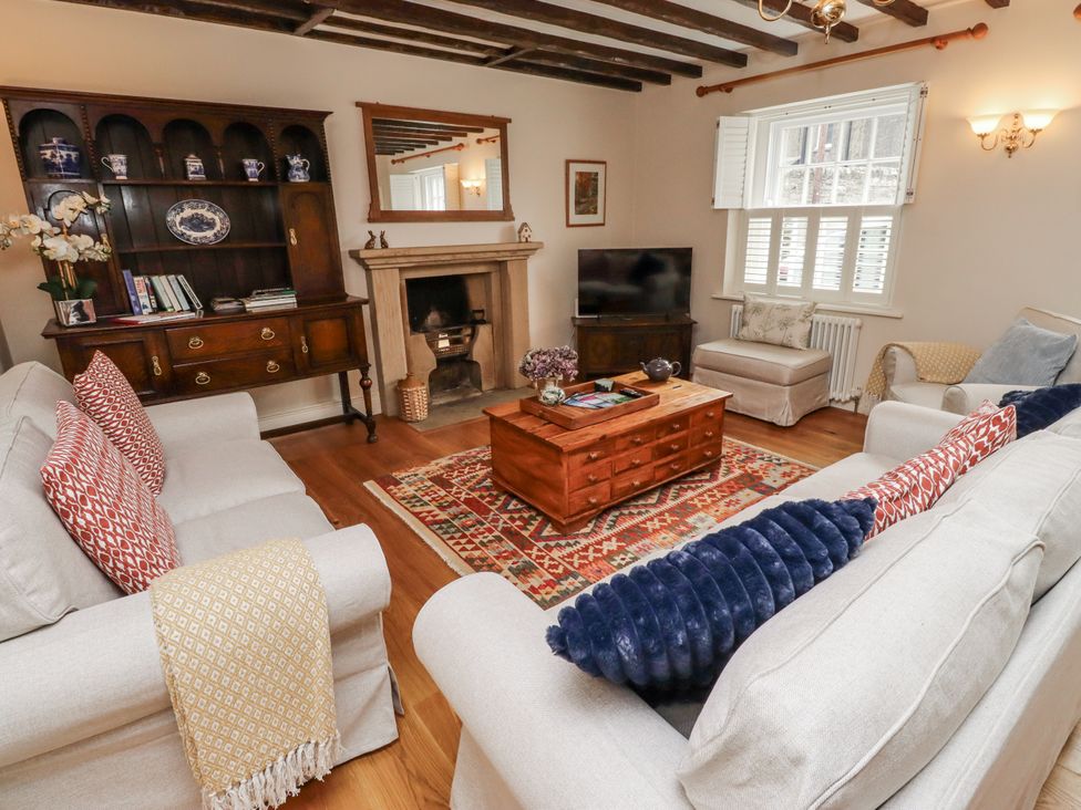 A living room with a television and a fireplace at Peary House in Alnwick