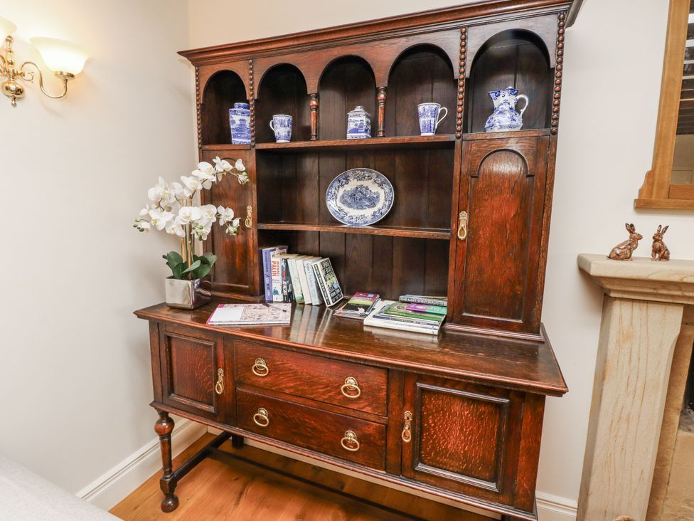 A display cabinet with books and crockery at Peary House in Alnwick