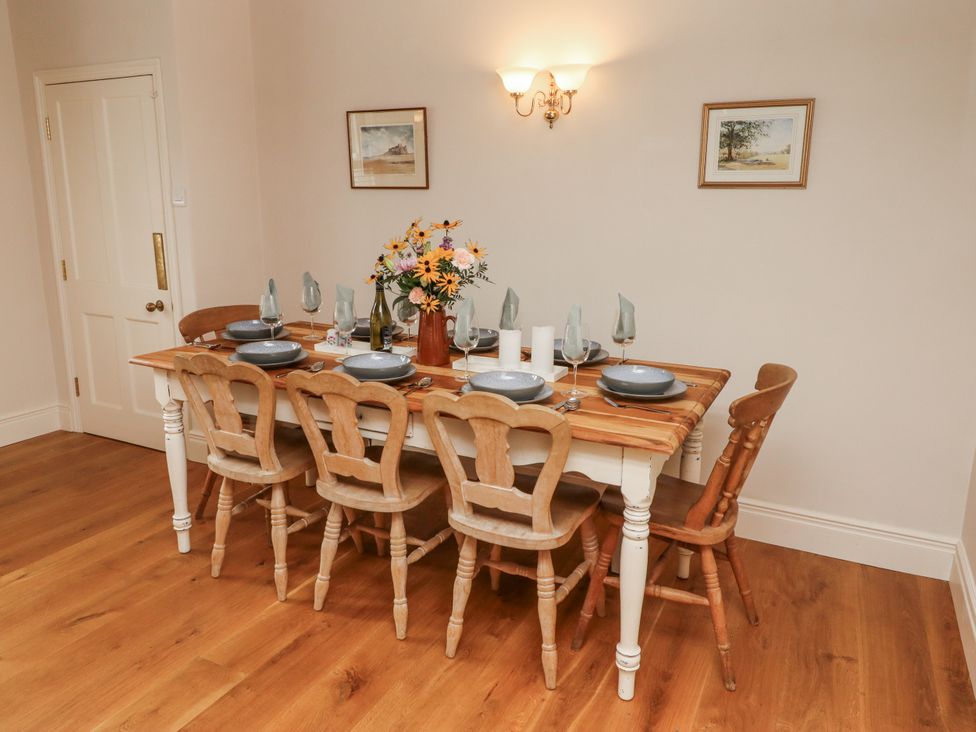 A dining room with a table set for dinner at Peary House in Alnwick