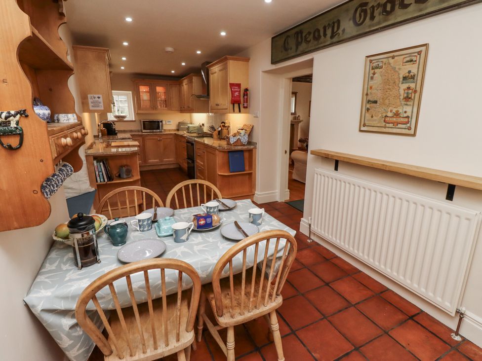 A kitchen with a dining table and chairs at Peary House in Alnwick