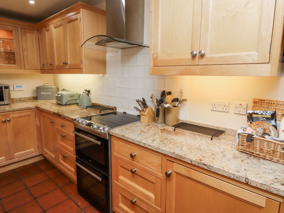 A kitchen with cabinets and appliances at Peary House in Alnwick