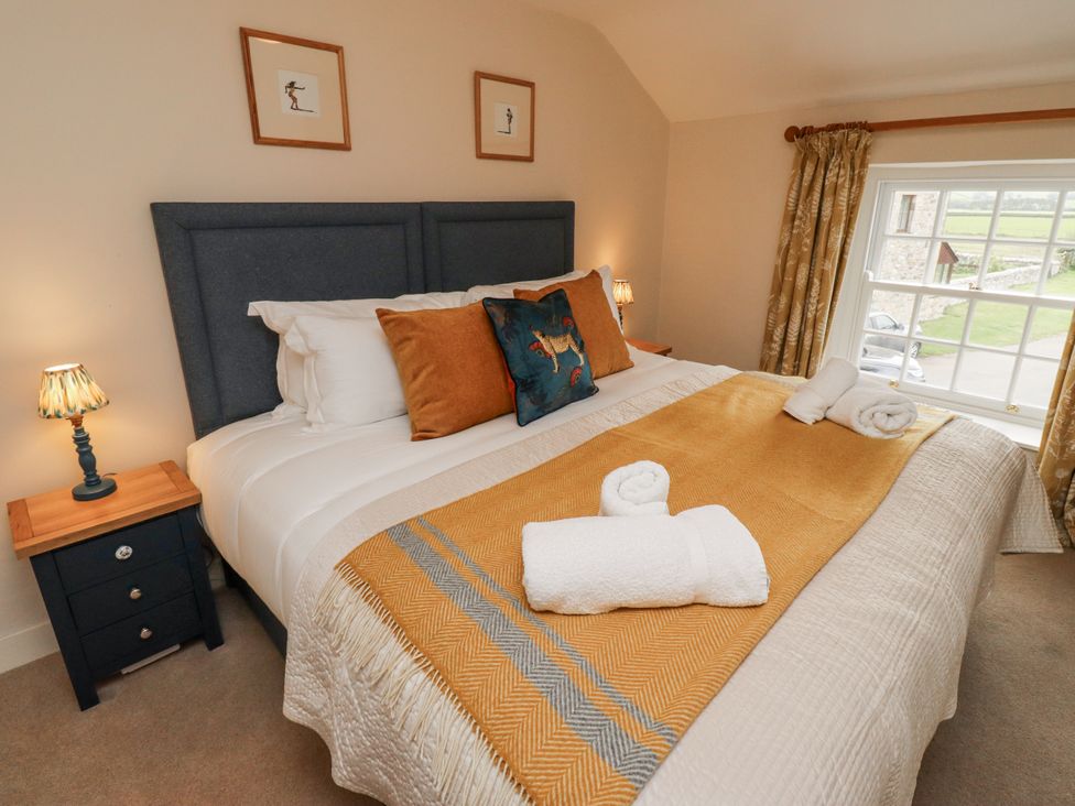A bedroom with a bed and nightstand at Peary House in Alnwick
