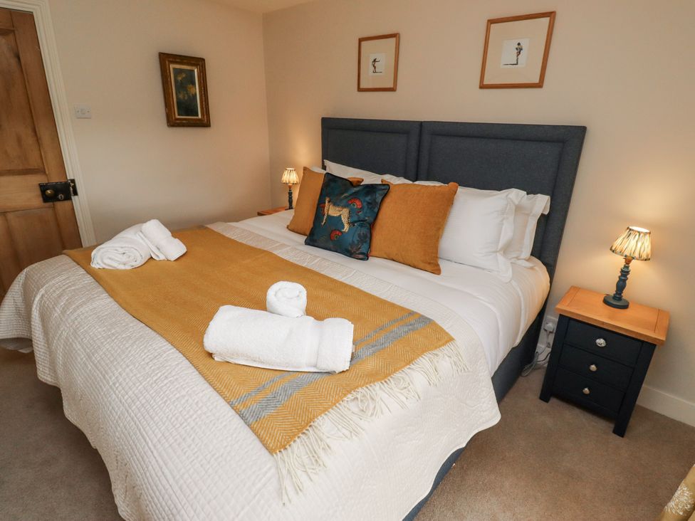 A bedroom with a bed and decorative pillows at Peary House in Alnwick