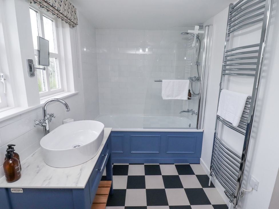 A bathroom with a bathtub and sink at Peary House in Alnwick